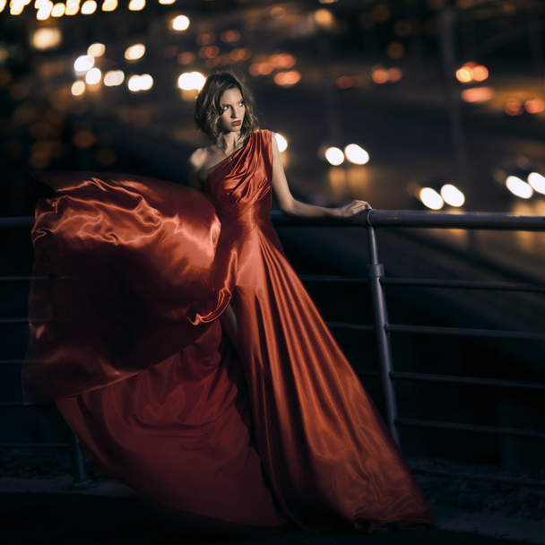 Sexy young beauty woman in fluttering red dress - Fotografie, Obrázek