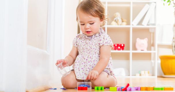 toddler girl playing with her toys  - Φωτογραφία, εικόνα