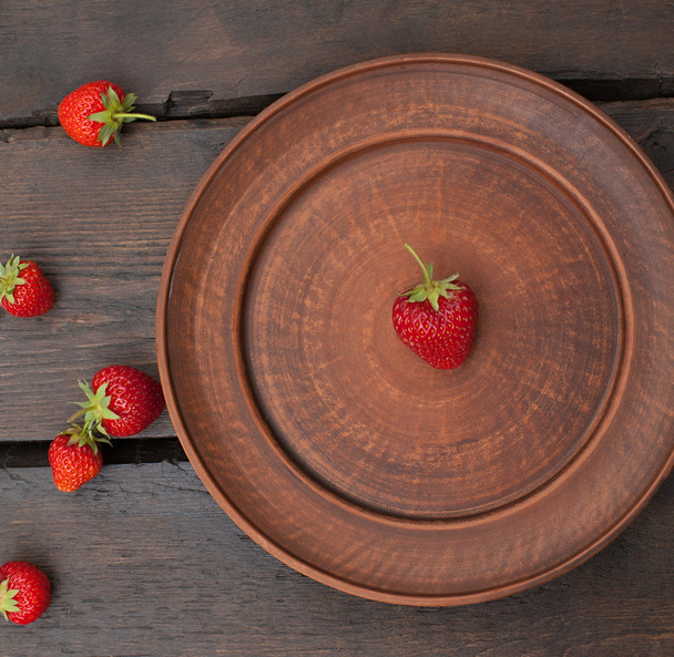 Strawberry sprinkled  on a  table - Fotó, kép