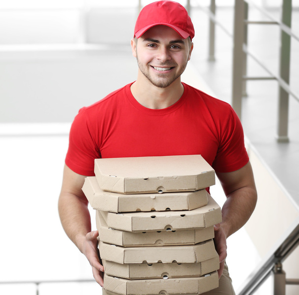 handsome man delivering pizza - Fotó, kép