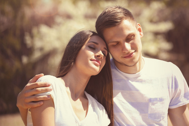 Young couple embracing outdoors in daylight - Valokuva, kuva