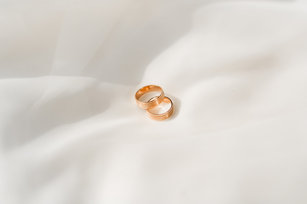 luxury wedding rings lying on the leaves and grass - Photo, Image
