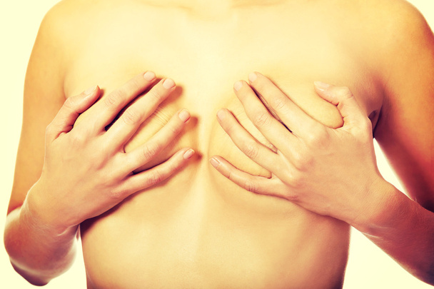 Topless woman covering her breast - Фото, зображення