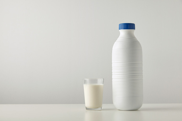 glass with organic milk near plastic bottle - Foto, immagini