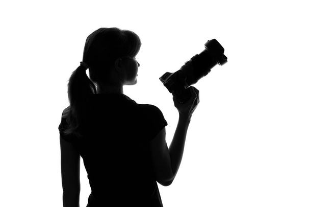 silhouette of a woman with a camera in hand - Fotoğraf, Görsel