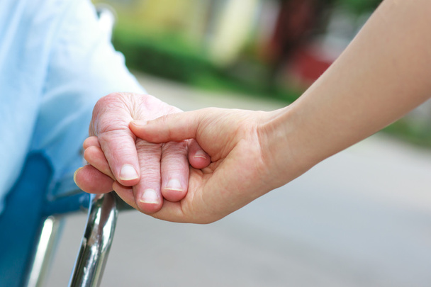 Senior women in wheelchair holding hands - Fotó, kép
