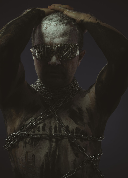 Man with metal chains  - 写真・画像