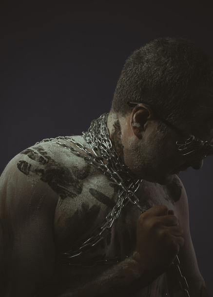 Man with metal chains  - 写真・画像