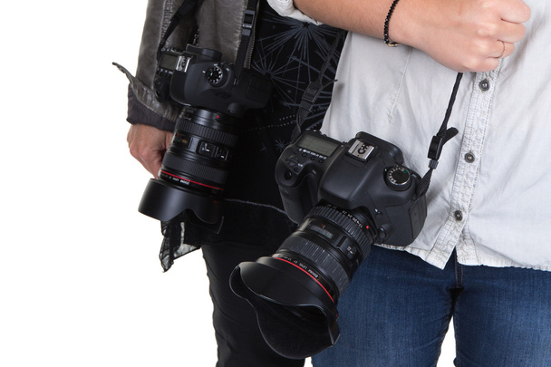 Image of two women holding camera in studio - Photo, Image