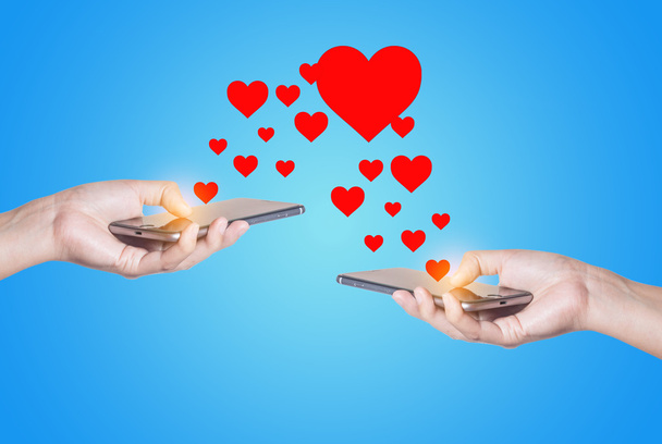 Hands with mobile phone and hearts - Fotoğraf, Görsel