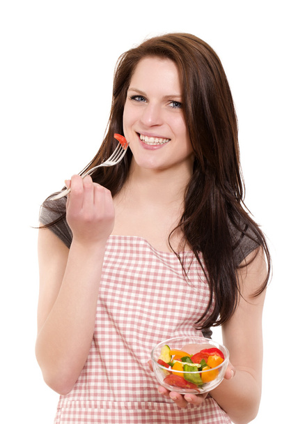 Young woman eating salad - 写真・画像