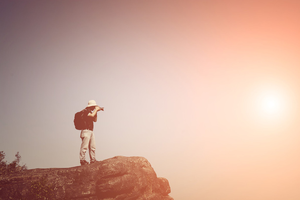 Фотограф, стоящий на вершине горы
  - Фото, изображение