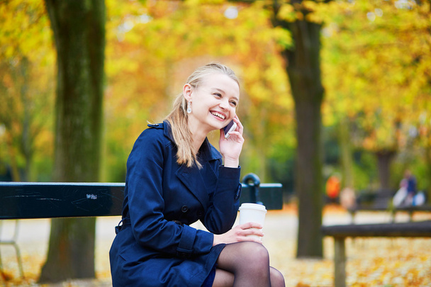 Young woman in the Luxembourg garden of Paris on a fall day - Photo, image