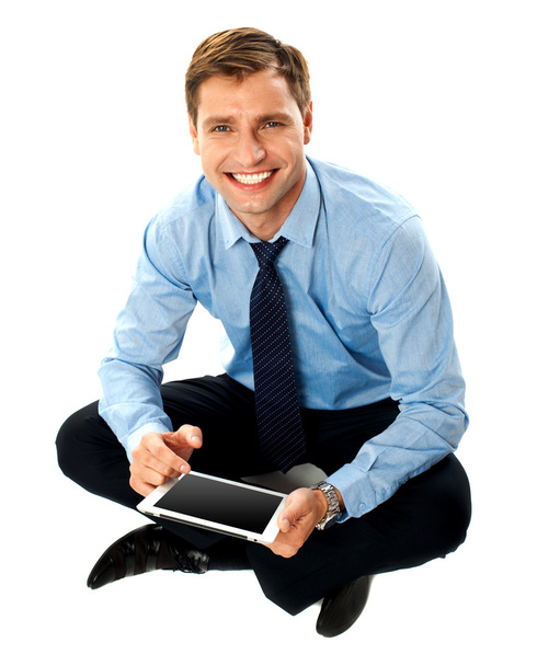 Man sitting on floor using touch screen device - Φωτογραφία, εικόνα