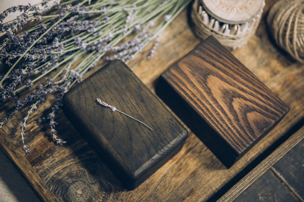 beautiful stylish wooden boxes lying on textile fabrics of cotton on a wooden tray - Fotografie, Obrázek