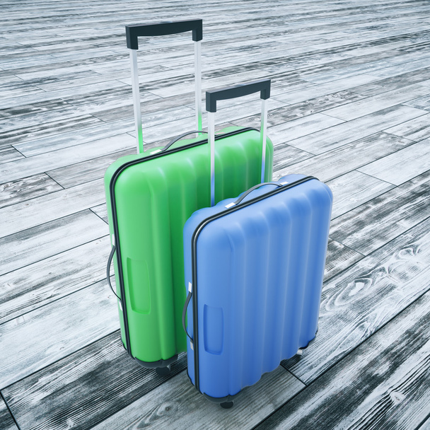 Suitcases on wooden background - 写真・画像