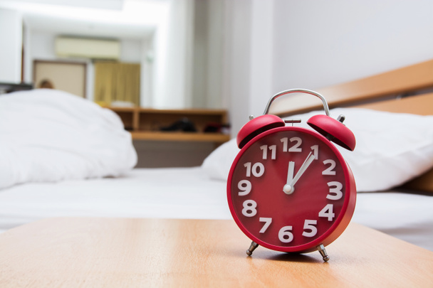 red alarm clock and bed - Photo, Image