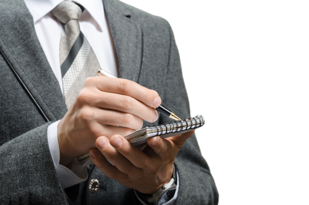 businessman in a suit puts data in notebook - Foto, Imagem