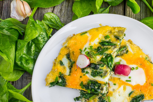 Top View on a Spinach Omelette with Radish on a White Plate  - Photo, Image
