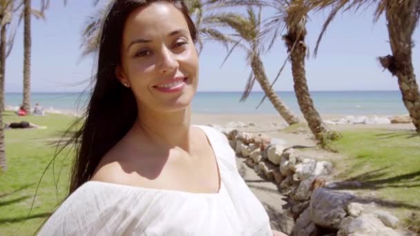 woman surrounded by palm trees and beach - Materiał filmowy, wideo