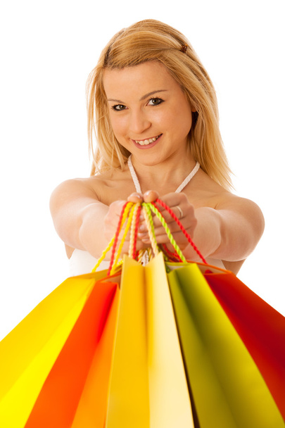 Cute blonde woman with shopping vibrant bags isolated over white - Foto, Bild