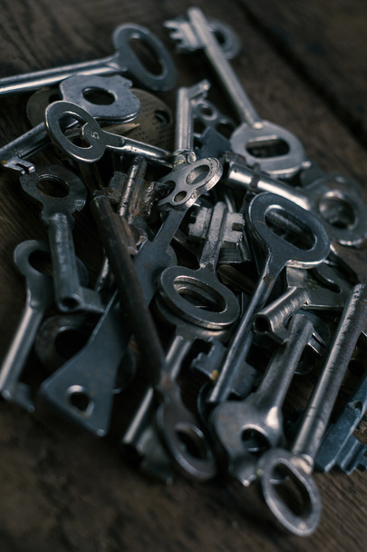 Set of keys on wood background. Tight focus with blur background - Foto, Imagem