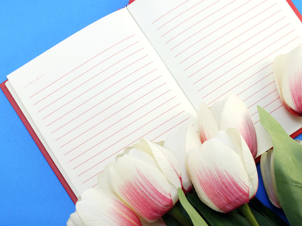 open notebook and beautiful pink tulip artificial flowers bouquet - Photo, Image