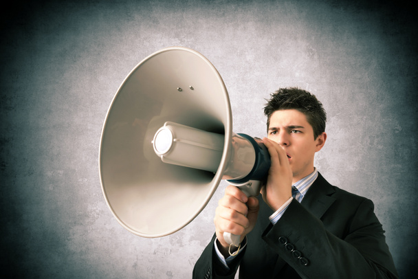 Young business with a megaphone - Photo, Image