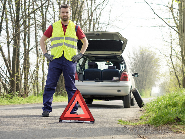 man fixing a car problem after vehicle breakdown on the road - Photo, image