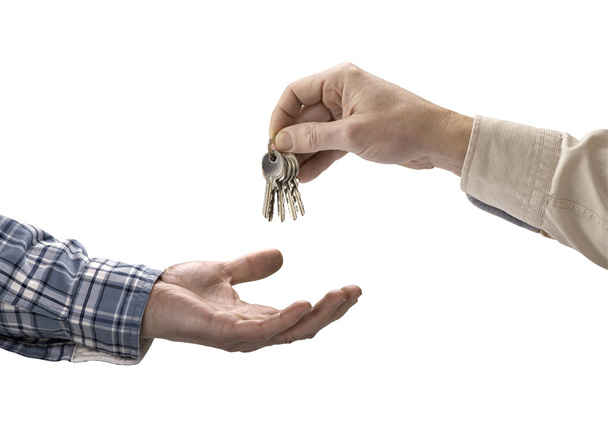 Man is handing a house key to a other man - Fotó, kép