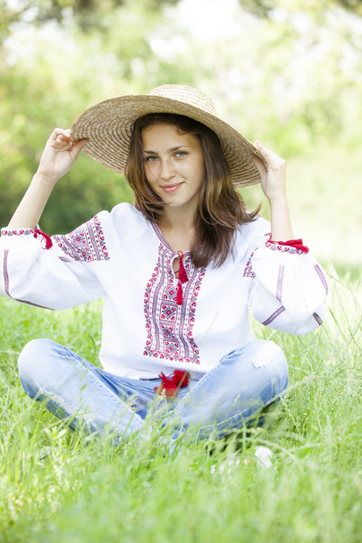 Slav teen girl at green meadow in national ukrainian clothing. - Φωτογραφία, εικόνα