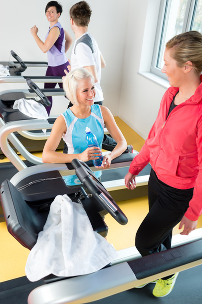 Young female friends chatting in fitness center - Photo, Image