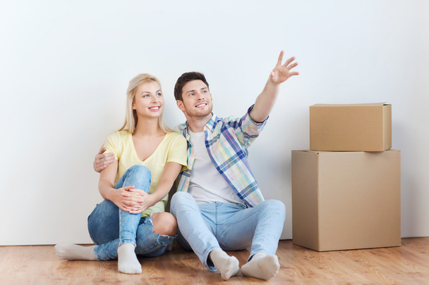 couple with boxes moving to new home and dreaming - Foto, Bild