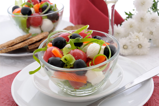 Салат из салата, помидоров черри, оливок и моцареллы с пе
 - Фото, изображение