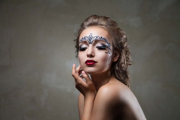 Sensual woman with face art and red lips looking down - Photo, Image