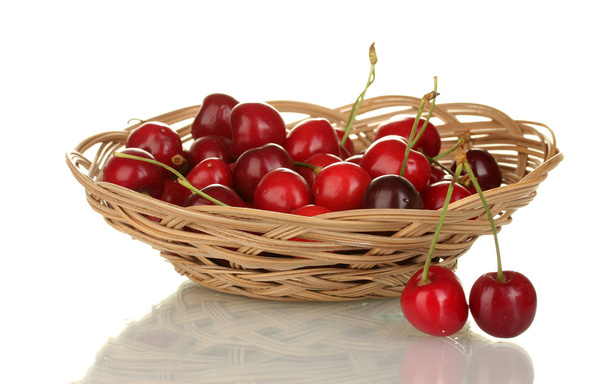 Cherry in wicker bowl isolated on white - 写真・画像