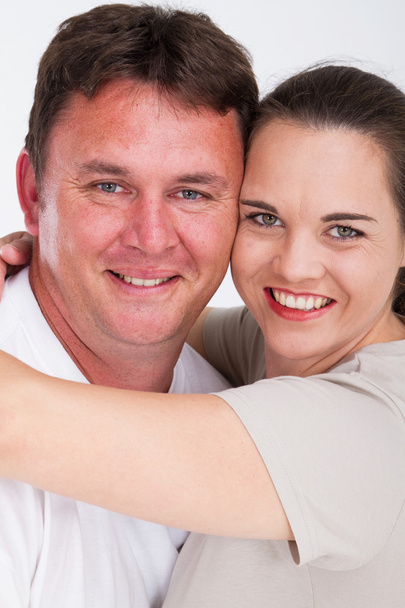 Middle aged couple smiling and hugging - Foto, Imagen