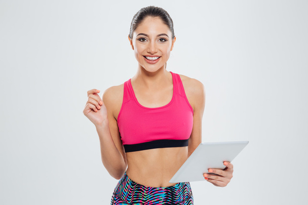 Happy sports woman using tablet computer - Zdjęcie, obraz