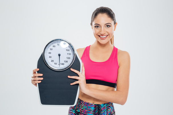 Fitness woman holding weighing machine - Фото, зображення