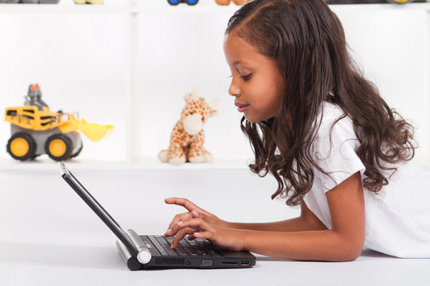 African american girl playing with laptop - Φωτογραφία, εικόνα
