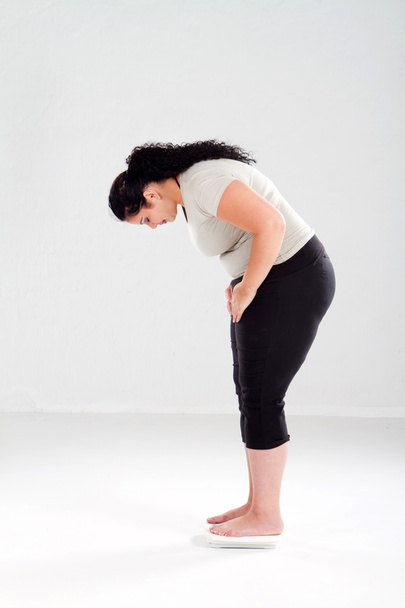 Overweight woman standing on scale - Valokuva, kuva
