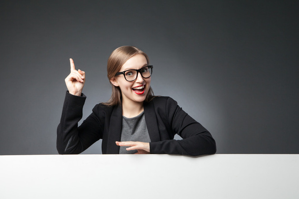 Woman in glasses and jacket with index finger up - Photo, Image