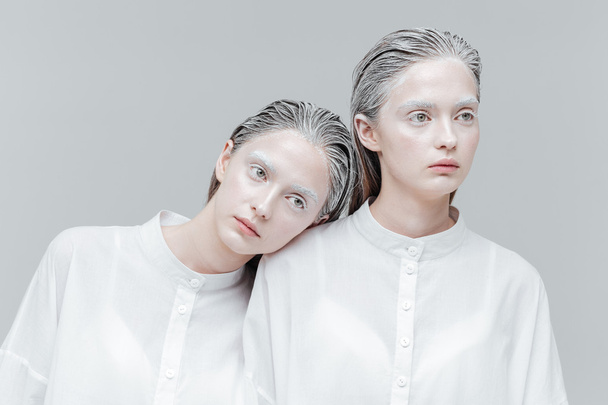 Close-up portrait of two women in smart white shirts  - Fotó, kép