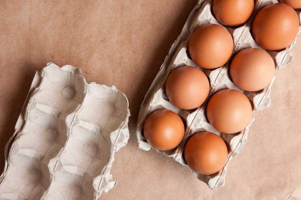 Chicken eggs in a tray on paper - Photo, Image