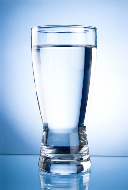Glass of water on a blue background - Photo, image