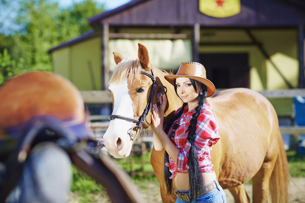 Portrait cowgirl in western style  with hors. - 写真・画像
