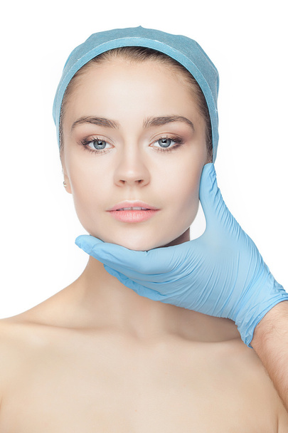 Plastic surgery concept. Doctor hands in gloves touching woman face - Foto, imagen