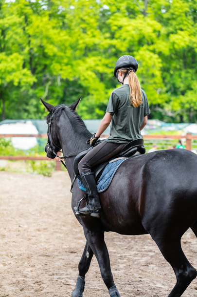 girl sportsman rides on horse  - Fotó, kép