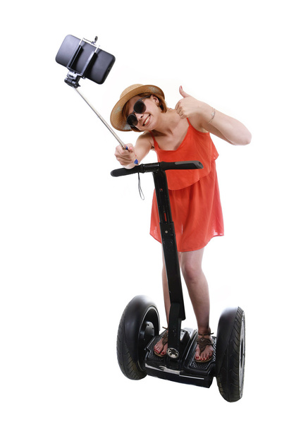 young chic tourist woman taking selfie photo with mobile phone while riding on segway - Foto, immagini