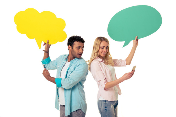 Couple with speech bubbles and gadgets - Photo, Image